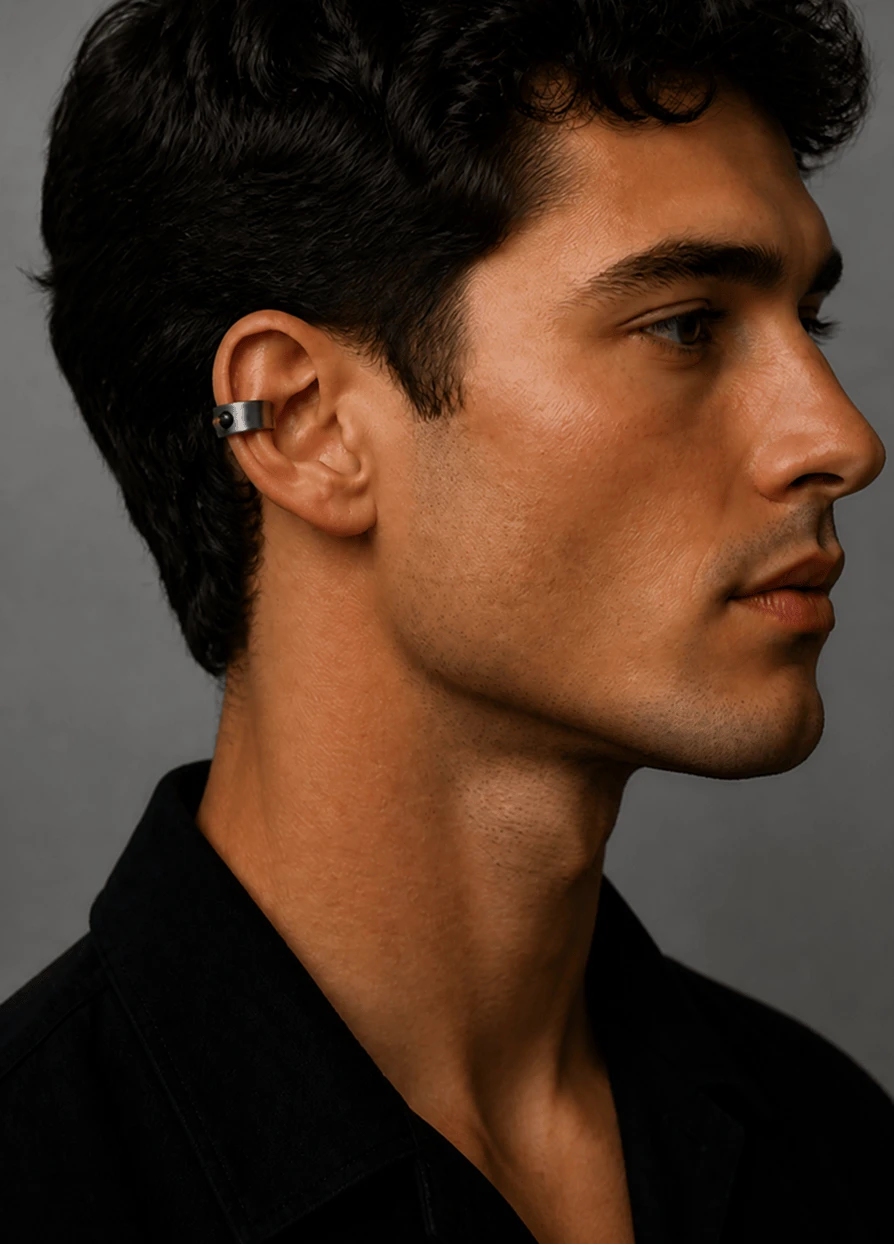 Man wearing the Mote titanium ear cuff, seen from behind
